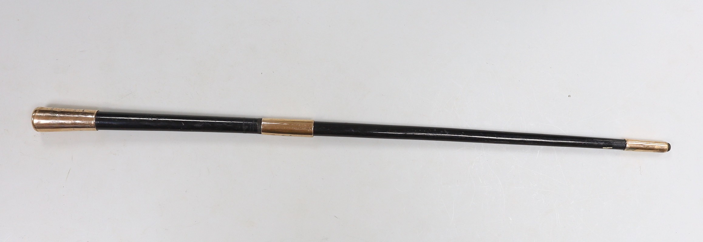 An Edwardian 9ct gold mounted ebonised baton, with presentation inscription to Mr. W.J. Bunny', maker Charles Edwards, London, 1908, 49.4cm.